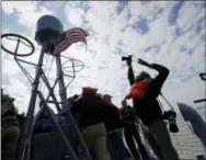  ?? GERALD HERBERT — THE ASSOCIATED PRESS ?? A photograph­er takes a photo of a flag during a media ride of the PT 305, which was restored by the National WWII Museum, on Lake Pontchartr­ain, where she was originally tested by Higgins Industries more than 70 years ago, in New Orleans, Thursday. The...