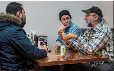  ?? Arkansas Democrat-Gazette/CARY JENKINS ?? Sonny Kay (clockwise from left), Zac Smith and engineer Bob Nagy hang out at SQZBX, the restaurant owned by Smith that is nextdoor to the KUHS studio in Hot Springs.