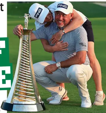  ??  ?? Loving it: Westwood with his caddie and girlfriend Helen Storey