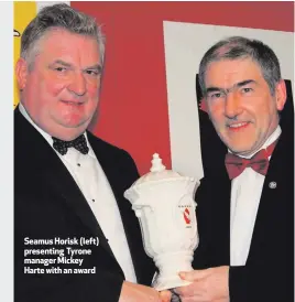  ??  ?? Seamus Horisk (left) presenting Tyrone manager Mickey Harte with an award