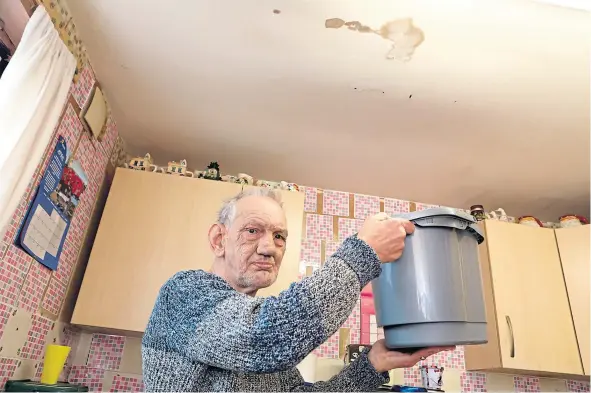  ??  ?? Robert Heath says his kitchen ceiling looks like it is about to cave in after water flooded in from the property above his home.