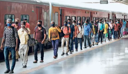  ??  ?? MIGRANT WORKERS from Uttar Pradesh and their families arriving back in Ahmedabad, on July 1. Many of those who went back home to Uttar Pradesh at the start of the lockdown have started returning to cities in other States in search of work.