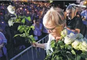  ?? Alik Keplicz / Associated Press ?? Malgorzata Gersdorf, head of Poland’s Supreme Court, hands roses to protesters at the court building in Warsaw, Poland, on Monday. The protests were over bills seen as assaults on the judicial system.