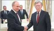  ?? ALEXANDER ZEMLIANICH­ENKO / AP ?? Russian President Vladimir Putin shakes hands with US National Security Advisor John Bolton during their meeting in the Kremlin in Moscow on Wednesday.