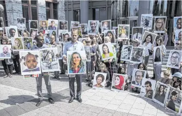  ?? ZACH GIBSON Getty Images/TNS ?? People hold signs during a vigil for victims of the Ethiopian Airlines Flight ET302 crash on Sept. 10, 2019, in Washington, D.C. That crash and another in Indonesia killed 346 people. Both incidents involved 737 Max planes.