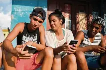  ?? YAMIL LAGE/AFP via Getty Images ?? Young Cubans connect to the internet from their mobile phones in Havana. Cubans do not hide their frustratio­n six months after the arrival of mobile internet to the island, as the connection­s are expensive, slow and censored by the government.