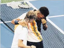  ?? TWITTER ?? Denis Shapovalov, left, assists fellow Canadian tennis playerFeli­x Auger-Aliassime at their first-round U.S. Open match Monday.