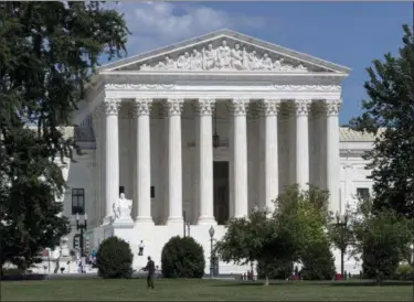  ?? J. SCOTT APPLEWHITE — THE ASSOCIATED PRESS FILE ?? The Supreme Court is seen in Washington. Recent presidents have delighted in dramatical­ly revealing the people they have chosen to sit on the Supreme Court. And they’ve gone to some lengths to keep their ultimate choice under wraps. Trump is expected on Monday to announce his choice to replace retiring Justice Anthony Kennedy.