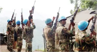  ??  ?? File photo showing Indian soldiers, serving in the UN peacekeepi­ng mission in Congo (MONUSCO), holding up their weapons at their base after patrolling the villages in Masisi, 88 km northwest of Goma. (Reuters)