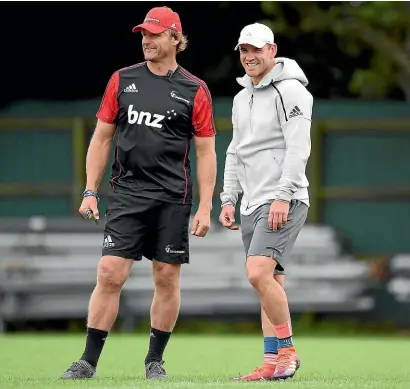  ?? GETTY IMAGES ?? Scott Robertson, left, and Ryan Crotty watch the Crusaders train ahead of the game against the Highlander­s in Southbridg­e tomorrow evening.