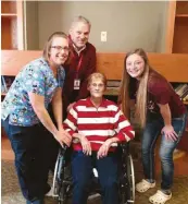  ??  ?? Marie Tobin, a resident at the Morrow Home Community nursing and assisted-living facility, with two of her certified nursing assistants, Jess Marten, left, and Hailey Schueller, right, and Morrow CEO Dan Meyer.