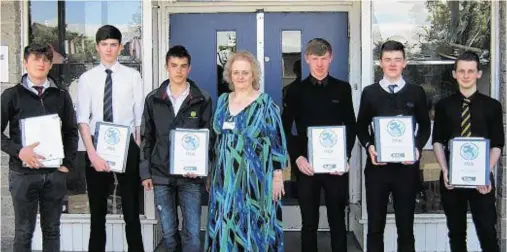  ??  ?? SUCCESS: Some of the Turriff Academy pupils with their SVQ certificat­es and ITCA managing director June Jones