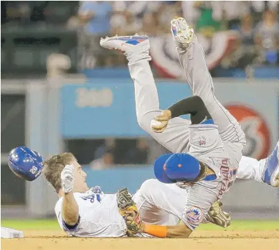  ?? | AP ?? Mets shortstop Ruben Tejada tumbles over Dodgers baserunner Chase Utley on a collision Saturday. He suffered a broken leg.