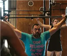  ??  ?? Mikey Muña works out during a CrossFit at Derive Athletics.