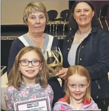  ?? Photograph: Kevin McGlynn. ?? Winner of the clootie dumpling Anne Napier with her helpers Hayley Napier, five, and Emma Murdoch, eight, with judge Lillian MacDonald.