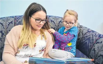  ?? ERIC MCCARTHY/JOURNAL PIONEER ?? Hannah Adams, three, enjoys some one-on-one story time with CHANCES early learning centre staff member Tori McCue.