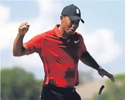  ?? Picture: Getty. ?? Tiger Woods celebrates as he holes his putt on the sixth hole in yesterday’s final round.