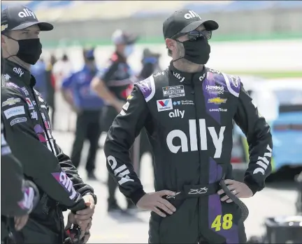  ?? MARK HUMPHREY PHOTOS — THE ASSOCIATED PRESS ?? Jimmie Johnson, right, waits for the start of Sunday’s NASCAR Cup Series at Kentucky Speedway. Johnson is not happy after an incident with Rochester Hills native Brad Keselowski during the race in which Keselowski bumped Johnson from contention following a late restart.