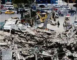  ?? LOUAI BESHARA/AFP VIA GETTY IMAGES ?? Rescuers searched the rubble of a building annexed to the Iranian embassy after an airstrike in Damascus Monday.