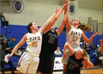  ?? AUSTIN HERTZOG - DIGITAL FIRST MEDIA ?? Pope John Paul II’s Kayla Mesaros (21) and Kallan Bustynowic­z (13) battle for a rebound with Radnor’s Ellie Mueller (31) and Missy Massimino (13) during the second half of their District 1-5A playoff game Tuesday.