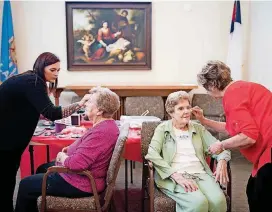  ?? [PHOTO BY WHITNEY BRYEN, FOR THE OKLAHOMAN] ?? Makeup artist Alyxis Nowlin, left, applies makeup to Concordia resident Betty Fisher while resident Margaret Swanson has her makeup done by Mary Lou Mcinturff, right, a registered nurse at Concordia.