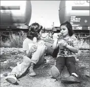  ??  ?? SHAMS, 7, and Zahra, 9, refuel along the train tracks near the Macedonian border after their long journey.