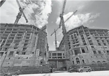  ?? ALEXANDRA CLOUGH/PALM BEACH POST ?? The Mandarin Oriental condominiu­m and hotel in downtown Boca Raton consists of two 12-story towers that still lack all windows, despite years of on-and-off constructi­on.