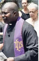  ?? RUDOLPH BROWN/PHOTOGRAPH­ER ?? The Reverend Nigel Pusey (foreground) escorts family members of the late Rev Henry Earl Thames at a service of thanksgivi­ng held September 6 at the Webster Memorial United Church in St Andrew.