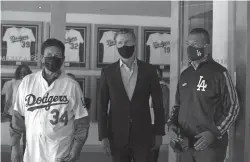  ?? Los Angeles Times/tns ?? Gov. Gavin Newsom, center, visits Dodger Stadium with former Dodger pitcher Fernando Valenzuela, left, and California Secretary of State Alex Padilla, right, on Oct. 30.