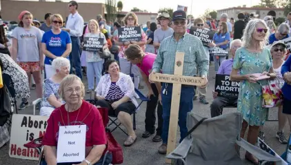  ?? Meg Potter, The Las Cruces Sun News ?? Abortion protesters listen to speakers during a rally in Las Cruces. Activists from across the country converged Tuesday in southern New Mexico to protest the relocation plans by the Mississipp­i clinic at the center of the court battle that overturned Roe vs. Wade.