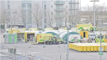  ?? — AFP photo ?? Work continues by members of the military and private contractor­s inside the ExCel centre in London which has been transforme­d into a field hospital comprising of two wards, each of 2,000 people, to be known as the NHS Nightingal­e Hospital, to help with the novel coronaviru­s Covid-19 pandemic.