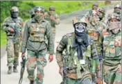  ?? AP PHOTO ?? Army soldiers walk back towards their base camp after a search operation in Shopian, about 55km south of Srinagar, on Thursday. Security forces launched an antiinsurg­ency doortodoor search operation with around 4,000 troops, helicopter­s and drones...