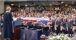  ?? BILL INGALLS/NASA/AFP ?? This image released by NASA shows Marines carrying the casket of former astronaut and US senator John Glenn during a ceremony to celebrate his life, on Saturday at Ohio State University’s Mershon Auditorium in Columbus.