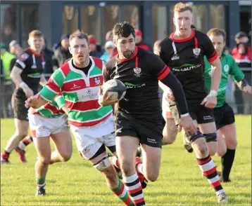  ??  ?? Enniscorth­y’s Ivan Poole makes a break, with Nick Doyle on hand if support is needed.