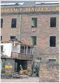  ??  ?? A fire badly damaged the mill in the 1950s, top; and, above, bulldozers move in this week.