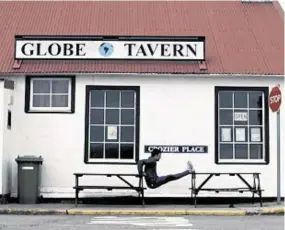  ??  ?? STRETCHING THE POINT: Argentine Olympian Fernando Zylberberg limbers up outside a pub in Port Stanley on the Falklands for his government’s TV advert