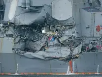  ?? EUGENE HOSHIKO/THE ASSOCIATED PRESS ?? The damaged part of USS Fitzgerald is seen Sunday at the U.S. Naval base in Yokosuka, southwest of Tokyo. Navy divers found a number of sailors’ bodies Sunday aboard the stricken USS Fitzgerald that collided with a container ship Saturday in the busy...