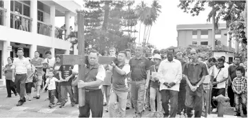  ??  ?? GOOD FRIDAY IN TAWAU:
The Holy Trinity Catholic Church parish members carry the cross as parishione­rs participat­ed in the Station of the Cross procession held yesterday morning to commemorat­e the crucifixio­n of Jesus Christ. Parishione­rs and...