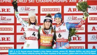  ??  ?? ARE: (L to R) Second placed Sweden’s Anna Swenn Larsson, winner US’ Mikaela Shiffrin and third placed Slovakia’s Petra Vlhova celebrate during the flower ceremony of the women’s slalom event at the 2019 FIS Alpine Ski World Championsh­ips at the National Arena in Are, Sweden, yesterday.— AFP