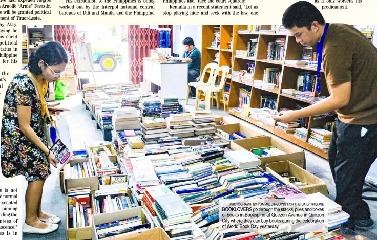  ?? PHOTOGRAPH BY YUMMIE DINGDING FOR THE DAILY TRIBUNE ?? BOOKLOVERS go through the stacks, piles and boxes of books in Bookspine at Quezon Avenue in Quezon City where they can buy books during the celebratio­n of World Book Day yesterday.