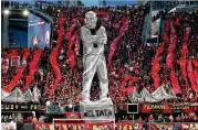  ?? CURTIS COMPTON / CCOMPTON@AJC.COM ?? Atlanta United fans raise a tifo of coach Gerardo Martino during the first half of the semifinal playoff match against New York last month.