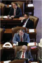  ?? Associated Press ?? Rep. Cecil Bell Jr., R-Magnolia, second from bottom, works at his desk Wednesday in the House Chamber at the Texas State Capitol in Austin. Republican­s control Congress and President Donald Trump has promised to drasticall­y cut federal regulation­s, but...