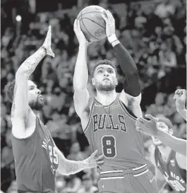  ?? MATTHEW STOCKMAN/GETTY ?? Bulls guard Zach LaVine goes to the basket against the Nuggets’ Austin Rivers, left, and P.J. Dozier in the third quarter Friday at Ball Arena in Denver. LaVine scored 36 points in the Bulls’
114-108 victory.