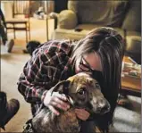  ?? Marcus Yam Los Angeles Times ?? ALEXANDRIA WILSON kisses her dog, Harley, after they escaped the Camp fire. They are now safe at a relative’s house.