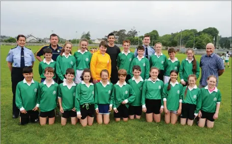  ??  ?? Fenit N.S. team taking part in the Garda Síochána and Cumann na Scol Football Blitz at na Gaeil GAA grounds on Friday and pictured with team Sgt. Eileen O’Sullivan, Colm Ó hAinifé, Cumann na Scol, Garda Aidan O’Mahony, Inspector Donal Ashe, and principal Fenit NS. Padraig O’Connell. Photo: John Cleary.