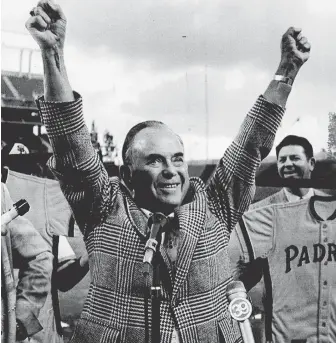  ?? HERALD FILE PHOTOS ?? PASSIONATE PAIR: Ray Kroc exults in 1974 as owner of the San Diego Padres. Joan Kroc, shown in 1987 handing a check to Elizabeth Taylor, far right, donated to many causes.