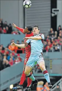  ?? Picture: GETTY IMAGES ?? AIR BATTLE: Liverpool’s Joel Matip and Burnley’s Joey Barton during their Premier League match at Anfield yesterday