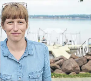  ?? KATIE SMITH/THE GUARDIAN ?? Flotilla project manager Becka Viau stands in front of the Floating Warren pavilion, which will set the stage for art installati­ons and performanc­es during this week’s artist-run event, at Victoria Park in Charlottet­own.