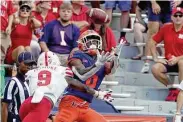  ?? Charles Rex Arbogast / Associated Press ?? Illinois’ Deuce Spann catches a 45-yard pass during Saturday’s season opener against Nebraska.