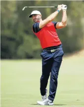  ?? DANIEL POCKETT/GETTY IMAGES ?? Dustin Johnson of the U.S. team practices at Royal Melbourne Golf Course ahead of the Presidents Cup.
Tiger Woods and Justin Thomas beat Joaquin Niemann and Marc Leishman 4 and 3 in fourballs (better-ball) competitio­n to open the Presidents Cup and give the American team a 1-0 lead. The other first-day matches were in progress at press time.